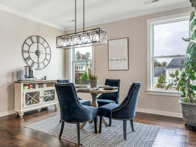 dining area featuring ornamental molding, plenty of natural light, and dark hardwood / wood-style floors