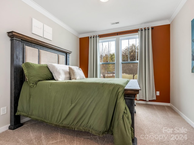 carpeted bedroom with ornamental molding