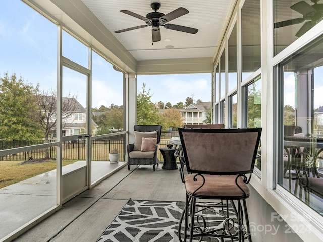 sunroom / solarium featuring ceiling fan