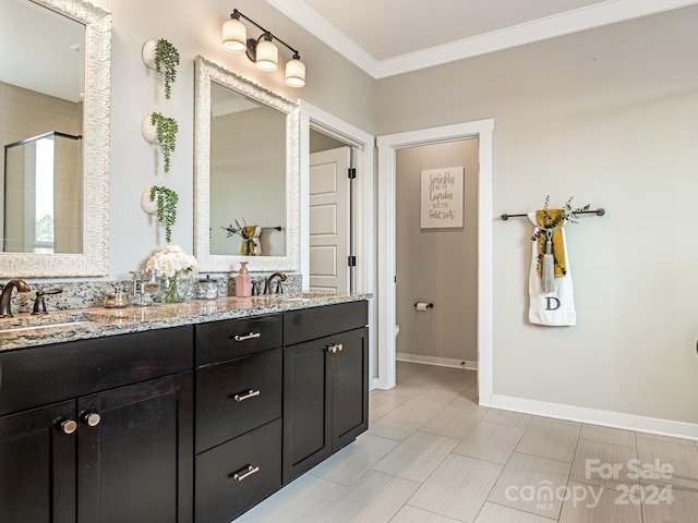 bathroom with a shower with door, vanity, toilet, and crown molding