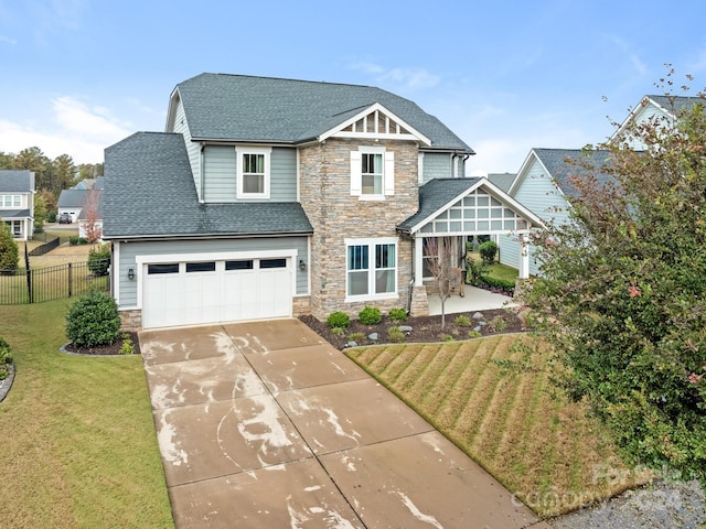 view of front of property featuring a front lawn and a garage