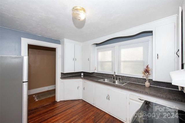 kitchen featuring white cabinets, stainless steel fridge, sink, and dark hardwood / wood-style flooring