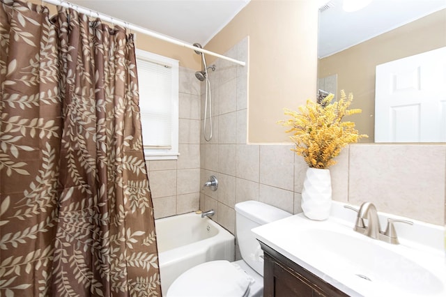 full bathroom with vanity, shower / tub combo, tile walls, and toilet