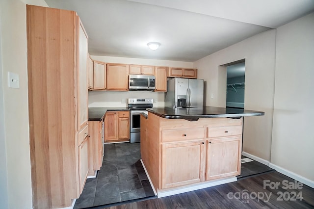 kitchen with dark hardwood / wood-style flooring, light brown cabinetry, appliances with stainless steel finishes, and a center island