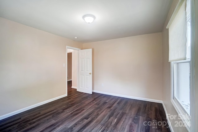 empty room featuring dark hardwood / wood-style flooring