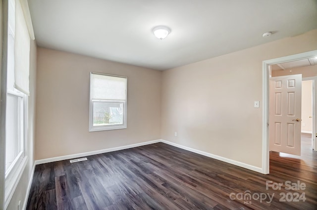 unfurnished room featuring dark hardwood / wood-style flooring