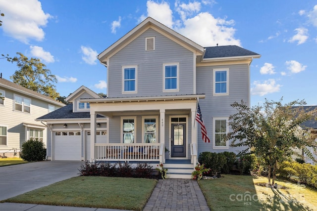 front of property with a garage, covered porch, and a front yard