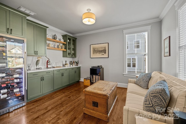 living room with crown molding, indoor bar, dark hardwood / wood-style floors, and wine cooler