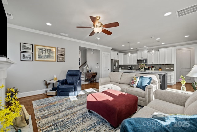 living room with dark hardwood / wood-style flooring, ornamental molding, and ceiling fan