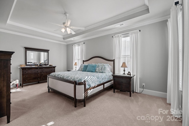 carpeted bedroom with crown molding, a raised ceiling, and ceiling fan