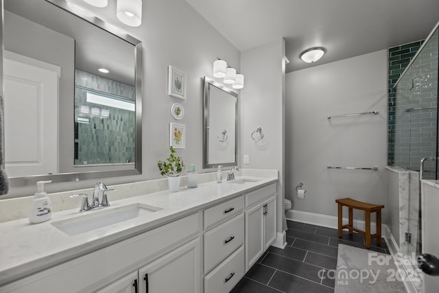 bathroom with tile patterned flooring, vanity, a shower with door, and toilet