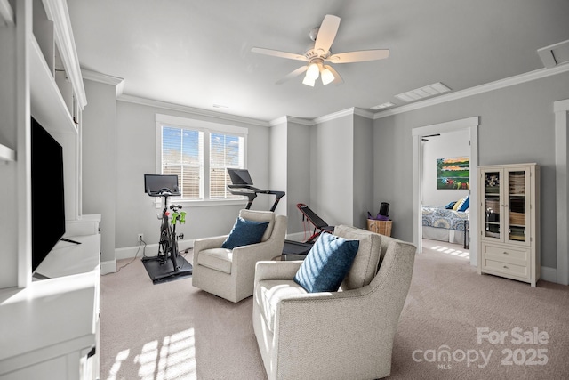 living room with crown molding, light colored carpet, and ceiling fan