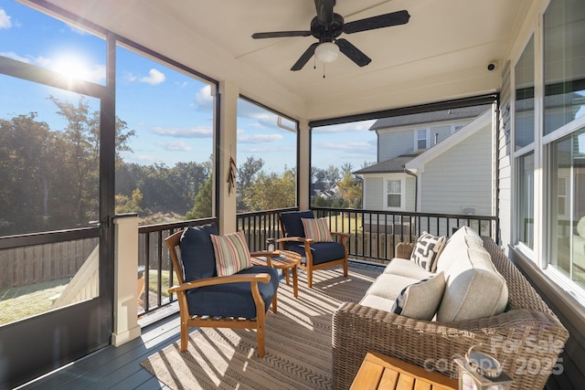 sunroom featuring ceiling fan and plenty of natural light