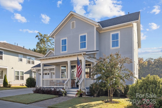 view of front of property with a porch and a front lawn