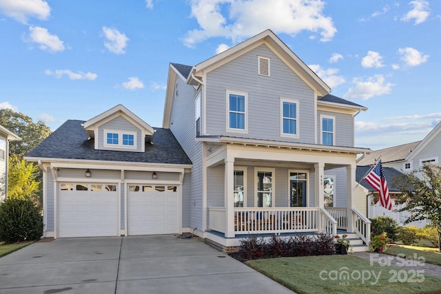 front facade with a garage, a front yard, and covered porch