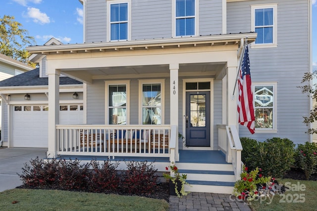 doorway to property with a garage and a porch