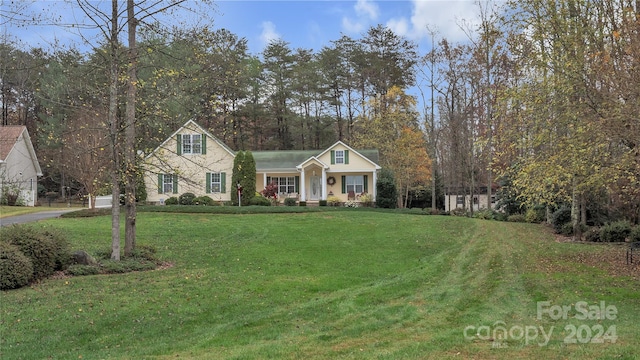 view of front of home featuring covered porch and a front yard