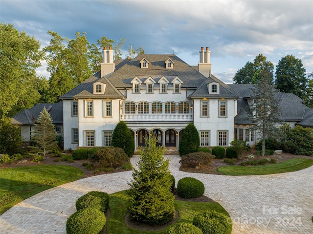 french provincial home with a balcony