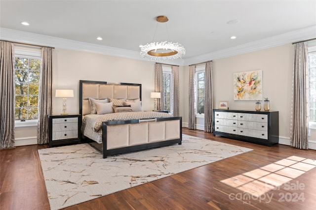 bedroom with wood-type flooring, an inviting chandelier, and crown molding