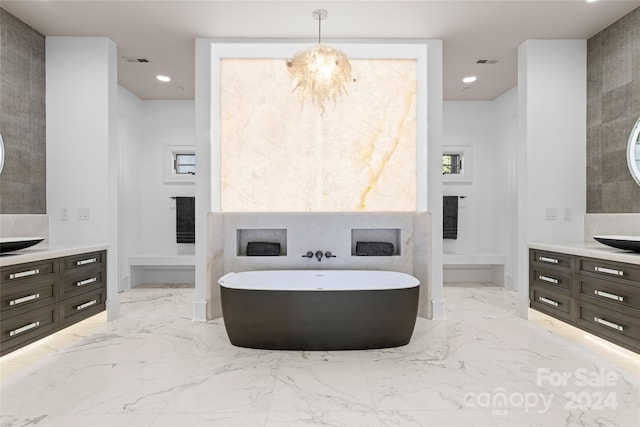 bathroom with a washtub, vanity, and an inviting chandelier