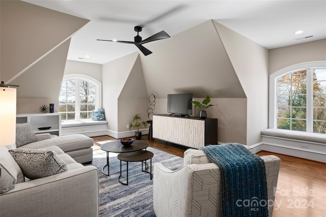 living room with a wealth of natural light, hardwood / wood-style floors, and ceiling fan