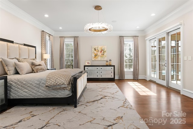 bedroom featuring multiple windows, access to outside, ornamental molding, and wood-type flooring