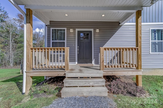 view of exterior entry with a porch