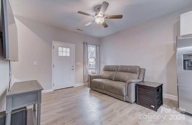 living room with light wood-type flooring and ceiling fan