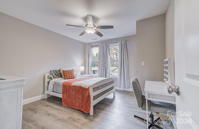 bedroom with light hardwood / wood-style floors and ceiling fan