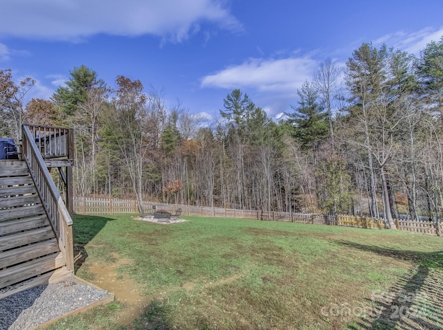 view of yard featuring a fire pit and a deck