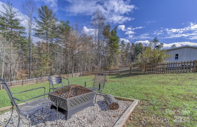 view of yard with a fire pit