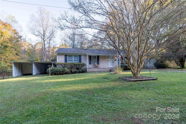 single story home with a carport and a front yard