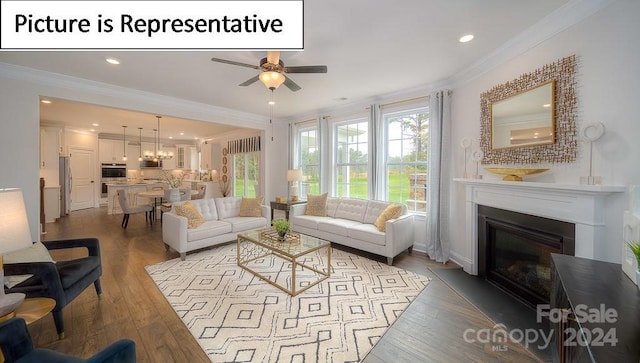 living room with ceiling fan with notable chandelier, wood-type flooring, and crown molding