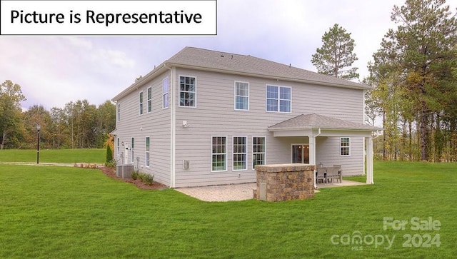 back of property featuring central AC, a patio area, and a yard