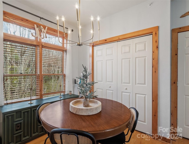 dining area featuring an inviting chandelier and light hardwood / wood-style flooring