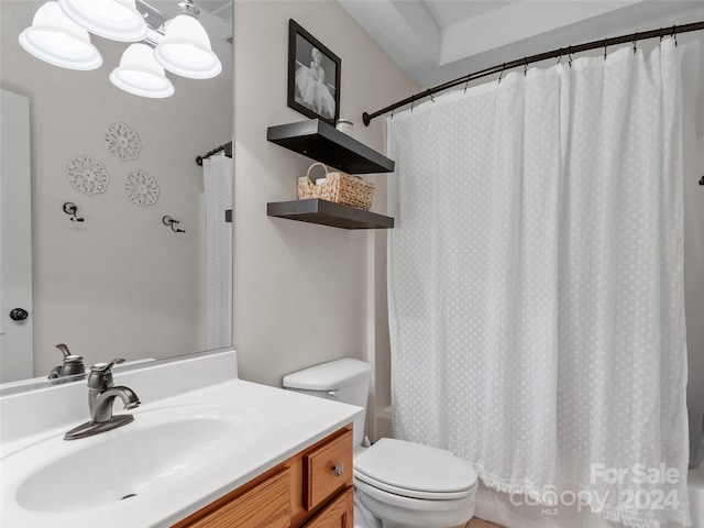 full bathroom with vanity, toilet, and shower / tub combo