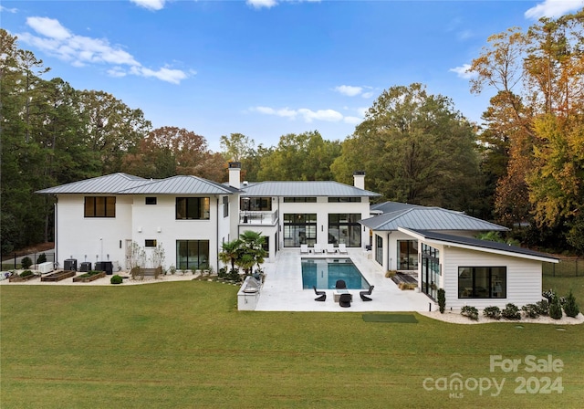 rear view of house with a lawn and a patio area