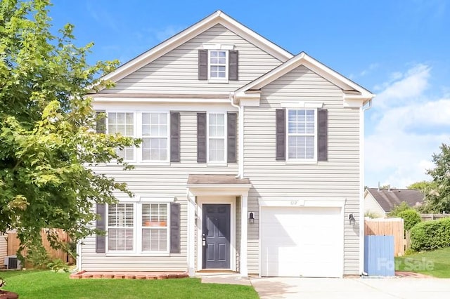 view of front of house featuring a front lawn, central air condition unit, and a garage