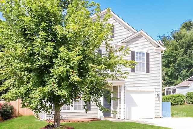 view of property hidden behind natural elements with a garage and a front yard