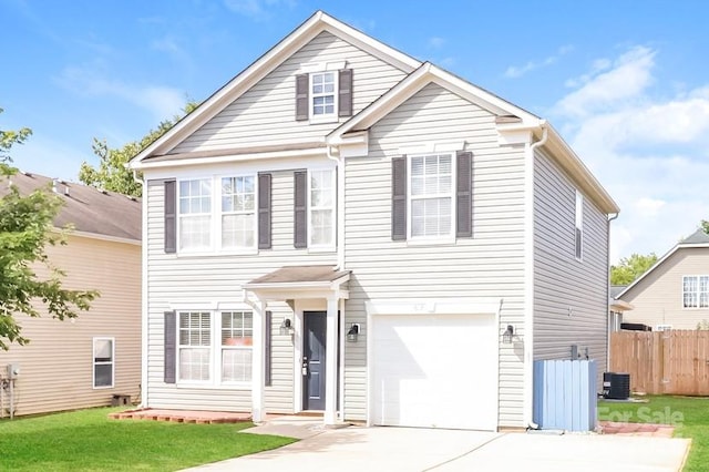 view of front facade with a front lawn, a garage, and central AC unit