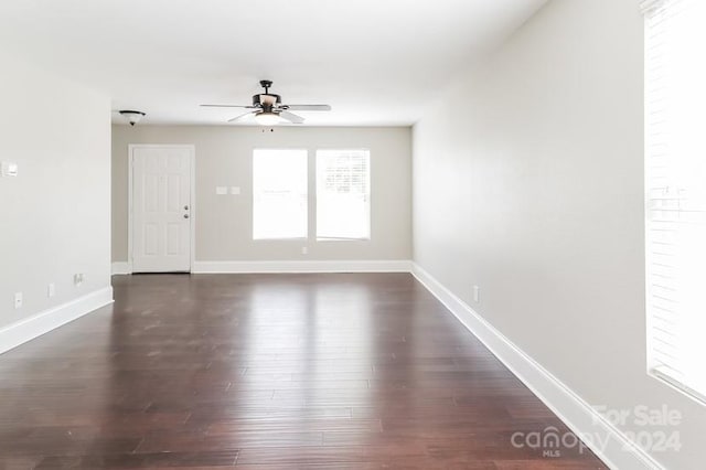 empty room featuring dark hardwood / wood-style flooring and ceiling fan