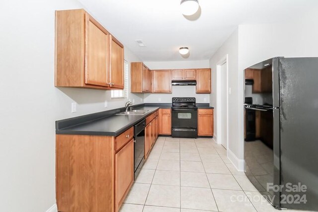 kitchen with black appliances, sink, and light tile patterned floors