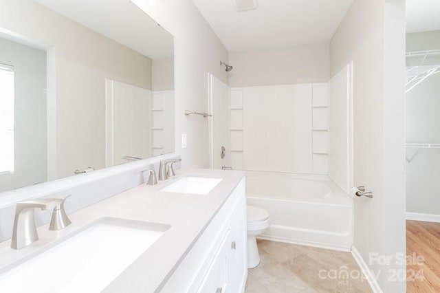 full bathroom with toilet, shower / bathing tub combination, vanity, and hardwood / wood-style flooring