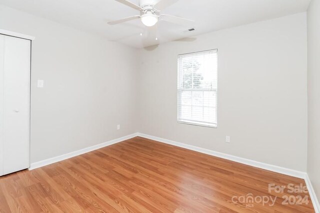 spare room with ceiling fan and wood-type flooring