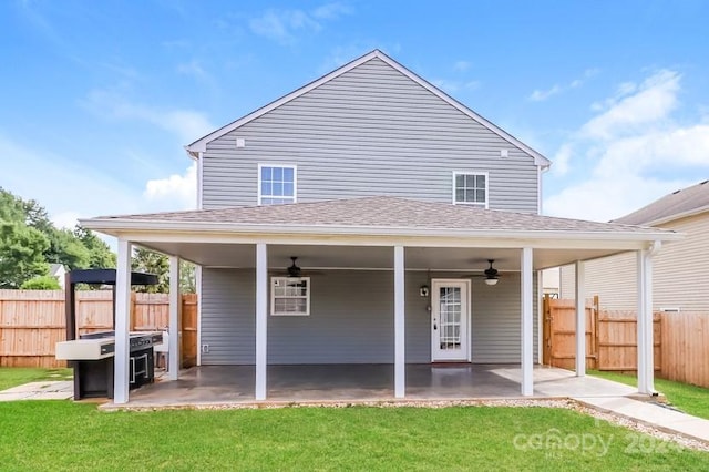 back of property with a patio area, a yard, and ceiling fan