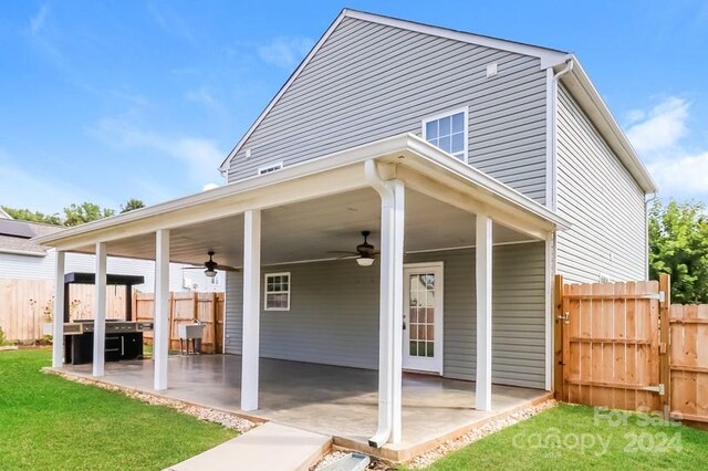 back of house with a lawn, ceiling fan, and a patio