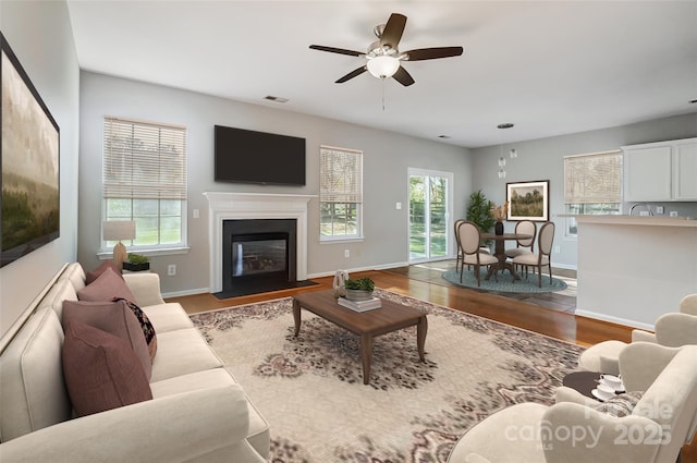 living room featuring ceiling fan and light hardwood / wood-style floors