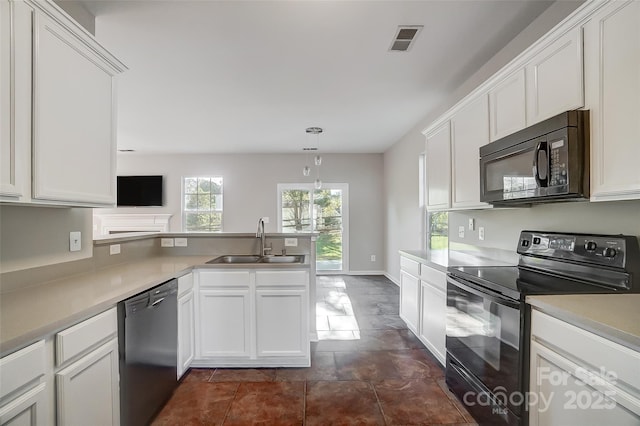 kitchen with black appliances, white cabinets, decorative light fixtures, and sink