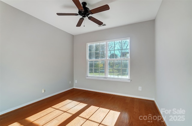 empty room with wood-type flooring and ceiling fan