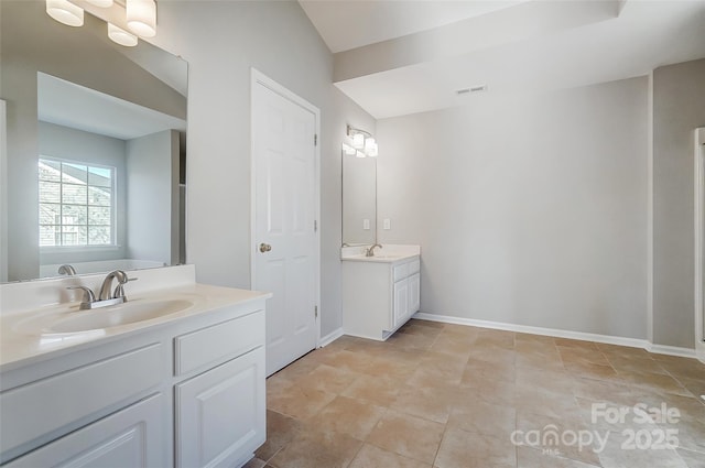 bathroom featuring tile patterned flooring and vanity